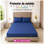 Referencia visual de un protector acolchado color azul oscuro con dos fundas de almohada; el diseño del acolchado puede variar